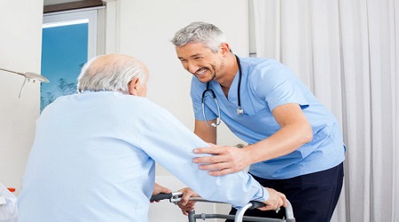 Male home nurse assisting elderly patient with medical care at home